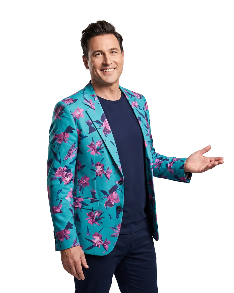 Buddy, smiling, holds out an open hand